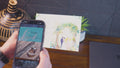 Phone camera scanning a printed wedding invitation to launch a personalized video message overlaid on the card