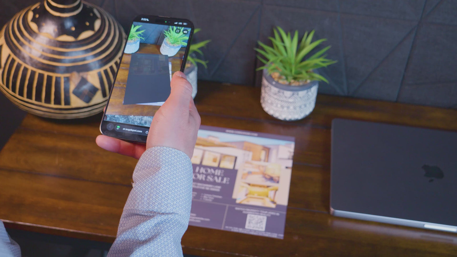 Augmented reality marketing demo — scanning a QR code on a printed flyer to reveal an interactive AR video experience on mobile phone